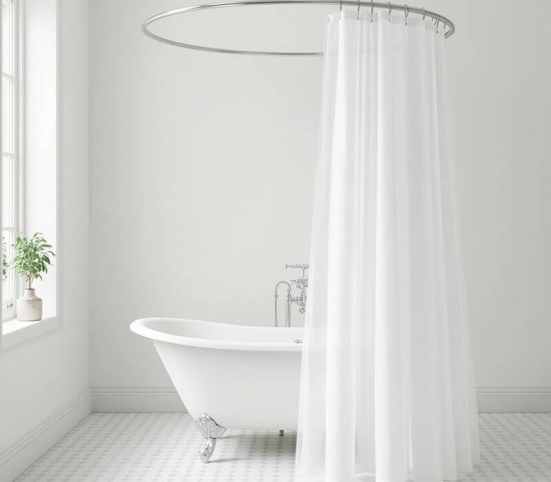 Wraparound shower curtain on an oval rod around a clawfoot bathtub